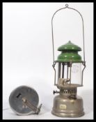 A vintage mid 20th century bakelite sea fishing reel by Alvey together with a vintage oil lamp.