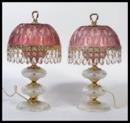 A pair of vintage 20th century glass table lamps having cranberry glass shades with gilt