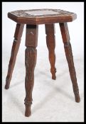 A 19th century Victorian carved oak stool having an octagonal top with a carved scrolled foliage