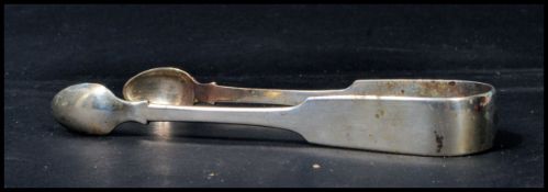 An early Victorian silver hallmarked pair of sugar nips tongs in the fiddle pattern being hallmarked