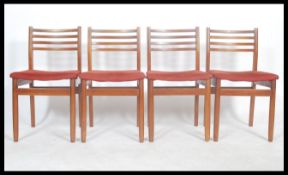A set of mid century dining chairs being of Danish influence having shaped legs with upper