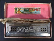 A Hohner Echo harmonica retaining original box and packaging instructions to the inner.