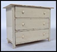 A vintage 20th century Edwardian apprentice pine chest of drawers, three long drawers raised on
