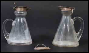 A pair of silver hallmarks glass whisky toddy decanters having silver hallmarked collar and caps,