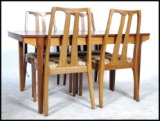 A retro 1970's teak wood extending dining table and chairs suite by Nathan Furniture. The table with