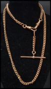 A hallmarked 9ct gold heavy double strand Albert chain having a T bar. Weighs 19.7 grams. Measures