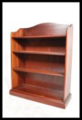 A good quality Parker Knoll 20th century open window bookcase cabinet raised on plinth base with a