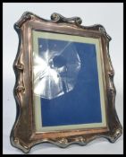 A large 20th century Vogel of London silver plated easel mirror in the Adams revival style marked
