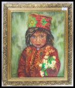 A 20th century oil on canvas painting - portrait study of a Tibetan child being signed to the corner