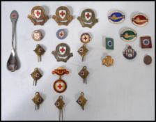 A good collection of early 20th century enamel badges to include British Red Cross, Complete Swimmer