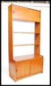A 1970's retro teak wood G-Plan upright bookcase cabinet having a series of open window shelves over