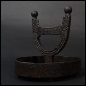 A 19th century Georgian cast iron boot scraper having a circular base and gallery with U shape