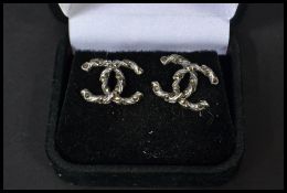 A pair of sterling silver interlocking Cs CZ designer earrings in presentation box.