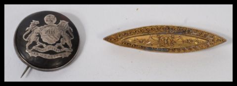 A vintage 20th century Edwardian gold metal bar brooch together with a silver hallmarked silver