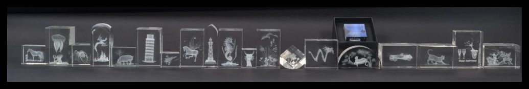 A good collection of over twenty laser cut glass paperweights dating from the 20th century,