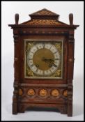 A late 19th / early 20th century German architectural oak cased bracket clock, fitted with a