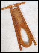 An early 20th century Arts and Crafts oak metamorphic folding riding boot remover