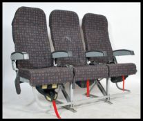 A set of 21st century Industrial Aircraft seats. The row of three with metal frames and original