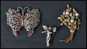 A group of three vintage 20th century brooches to include a silver gilt stamped 925 and pearl brooch