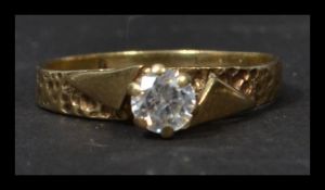 A vintage 9ct gold Art Deco solitaire ring set with a single white stone in a geometric setting.