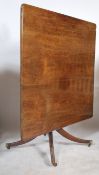 A 19th century Regency mahogany large tilt top breakfast table - loo dining table being raised on