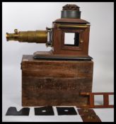 A vintage 20th century magic lantern slide viewer of wooden and brass construction set within a