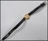 A ladies vintage 18ct / 750 marked cocktail dress watch having baton numerals with swiss jewel