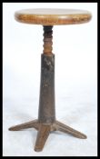 A vintage early 20th century Singer sewing machinist industrial stool raised on a quadruped cast