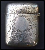 A silver hallmarked match Vesta case having a fitted hinged lid, chase decorated with foliate design