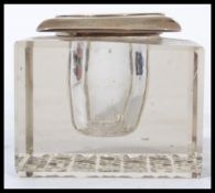 An early 20th century Mappin and Webb silver hallmarked topped inkwell and pen rest having a cut