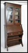 A late 19th / early 20th Century Arts & Crafts oak students bureau bookcase with Art Nouveau stained