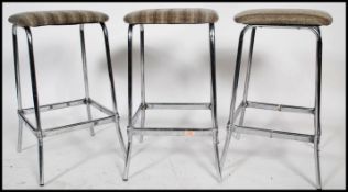 A set of 3 mid century chrome bar stools. Each wit
