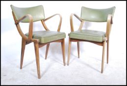 A pair of mid century Ben Chairs ( benchairs ) raised on angular bentwood frames with green