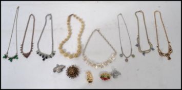 A collection of vintage 20th century 1950's rhinestone necklaces along with a 1920's carved