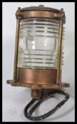 A vintage 20th century brass and wire caged mast lamp having clear glass lining, Stamped L.L.R.