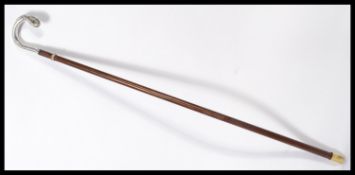 A vintage early 20th century silver hallmarked walking stick cane having a tapering wooden shaft.
