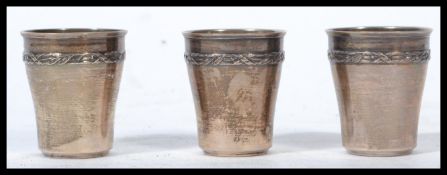 A group of three continental silver drinks measures toddy cups with continental silver marks to