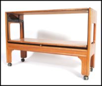 A retro 20th century Danish influece teak wood metamorphic two tier  buffet trolley raised on