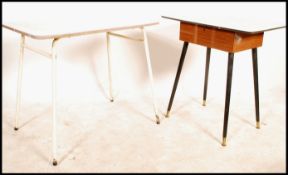 An unusual mid century teak wood and formica sewing table. The teak base with tapering legs having a