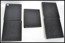 A group of postcard albums and sleeves in binders. Black vinyl albums.
