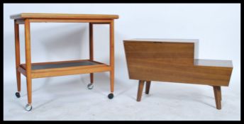 A 1970's / 20th century retro teak wood workbox being raised on angular legs with hinged top