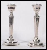 A pair of silver hallmarked filled stub candlesticks, Birmingham assay marks with makers marks for A