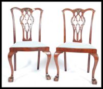 A pair of 19th century Georgian style mahogany chippendale dining chairs being raised on cabriole