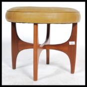 A retro 20th century teak wood circular G-Plan dressing table stool raised on teak wood x-cross base