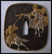 An Oriental Bronze Tsuba overlaid scenes of fighting warriors.