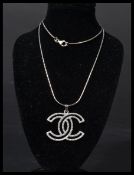 A silver designer necklace and pendant set with CZs complete in presentation box.