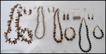 A collection of four good gemstone and other bead necklace, bracelets and earring sets. To include