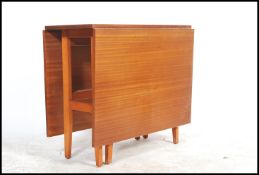 A mid century Avalon teak wood drop leaf dining table and set of 4 matching chairs. The chairs