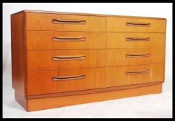 A 1970's G-Plan teak wood Kelso Pattern double chest of drawers being raised on an inset plinth with