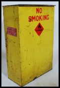 A vintage 20th century industrial metal Leyland's petrol bin being yellow enameled with danger